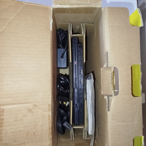 PlayStation 2 console with original controller, memory card and 2 games