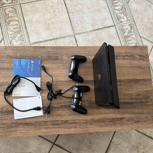 PlayStation 4 Slim 500GB used with 2 DualShock 4 controllers and accessories