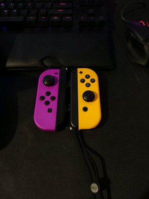 Nintendo Switch Joy-Con Neon Purple and Neon Orange like new with carrying case