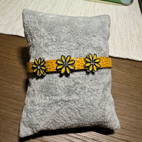 Bracelet with yellow leather strap like new with three metal charms