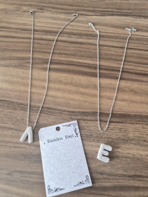 Necklaces with initials E and L stainless steel like new with rhinestones