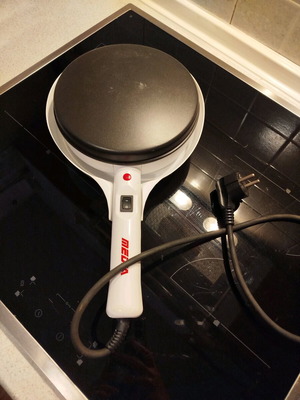 Electric handheld crepe maker like new with non-stick surface