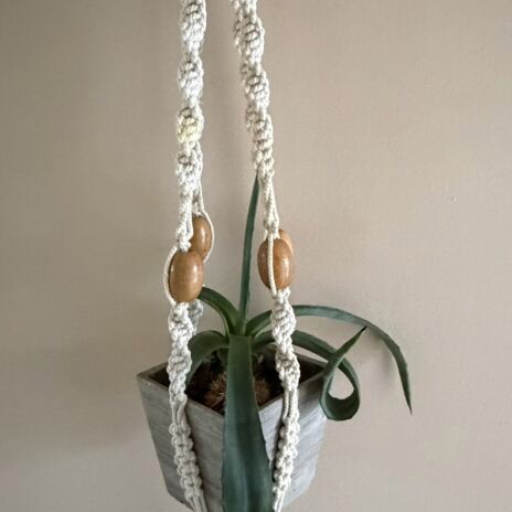 Macrame plant hanger used with wooden beads for pots