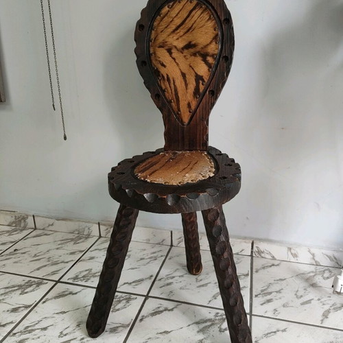 Spanish rustic chair used with three legs and animal leather from the 1960s