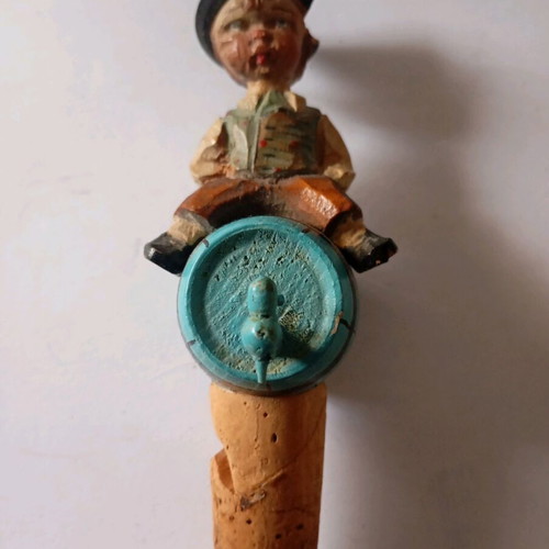 Cork used with carved wooden bottle stopper and boy figure