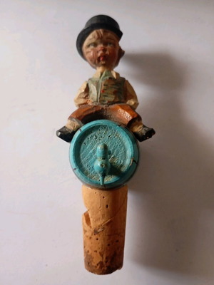 Cork used with carved wooden bottle stopper and boy figure