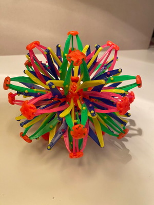 Multicolored plastic stress ball used with metal toy gift