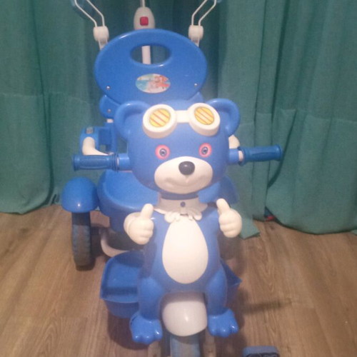 Baby blue tricycle used with canopy, storage, and adjustable parent handle