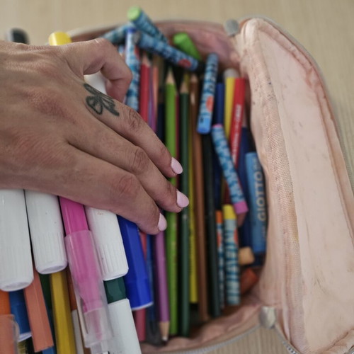 Makeup bag with markers, colored pencils, crayons, and watercolors used