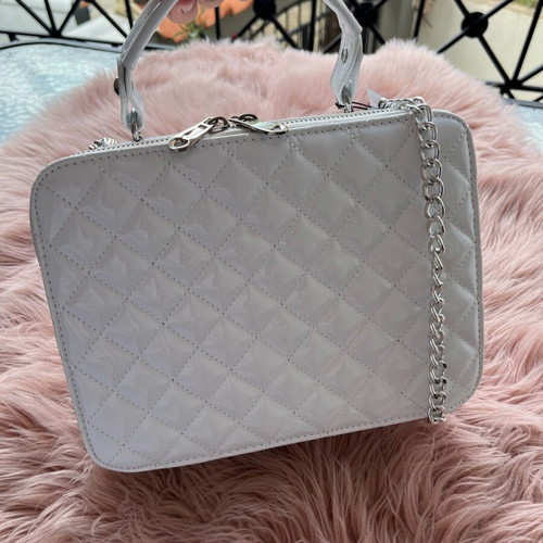 White lustrous bag with silver details and chain