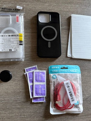 iPhone 16 Pro Max pack like new with cases, screen protectors, cable, and mount