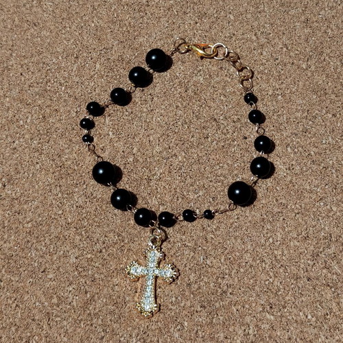 Bracelet with golden cross like new, black and gold