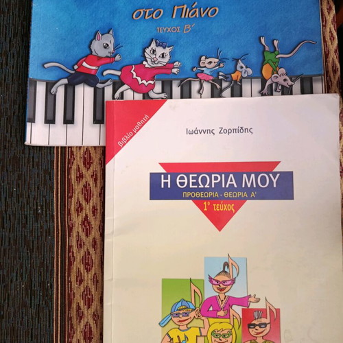 Piano learning books used, one with CD and one with writings