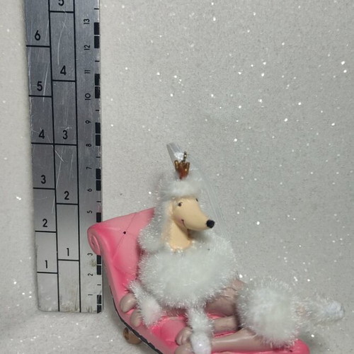 Dog ornament on chaise lounge, hanging decoration
