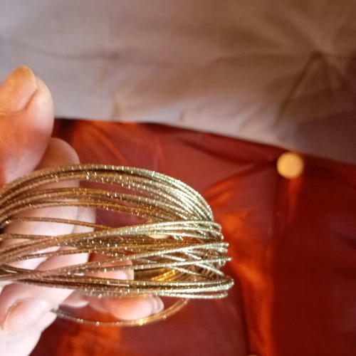 Bracelet made of 32 thin metal pieces like new, gold tone