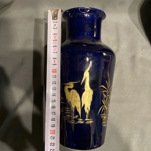 Old porcelain vase dark blue with gold designs used