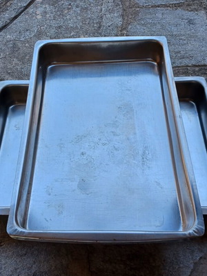 Set of two used stainless steel oven trays