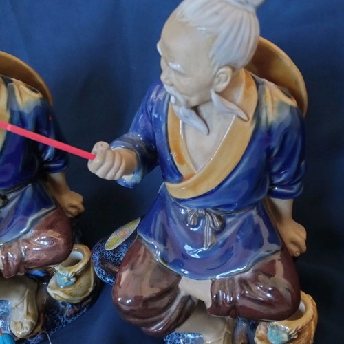 Decorative porcelain figurines used, two Chinese fishermen