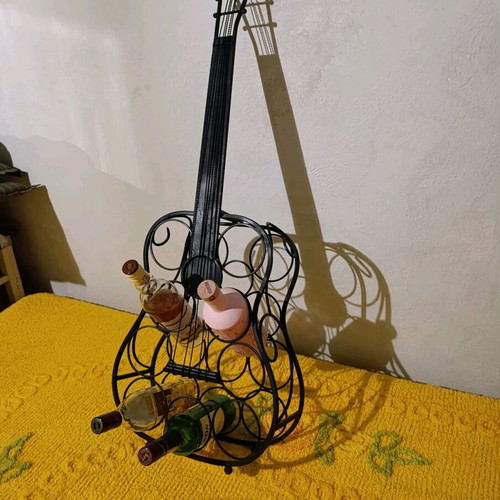 Metal guitar stand used for bottles vintage