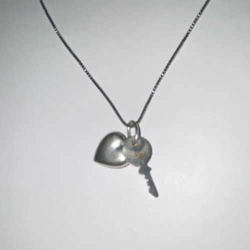 Silver necklace with heart and key used