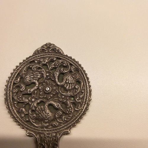 Carved old hand mirror used