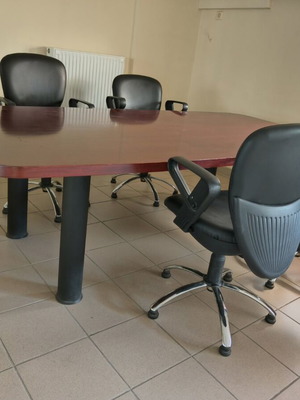 Conference table cherry wood with 6 leather swivel chairs like new