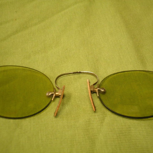Antique eyeglasses with green lens used