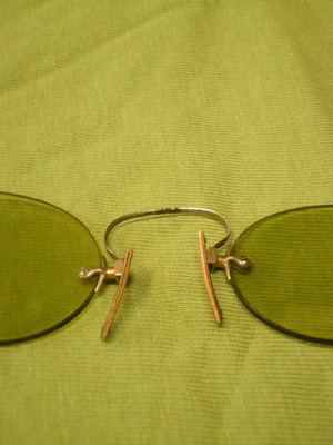 Antique eyeglasses with green lens used