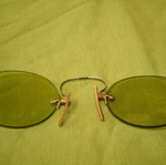 Antique eyeglasses with green lens used