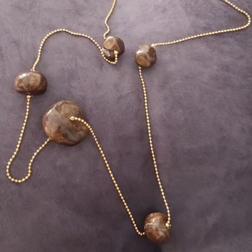 Faux necklace with long gold chain and large brown stones