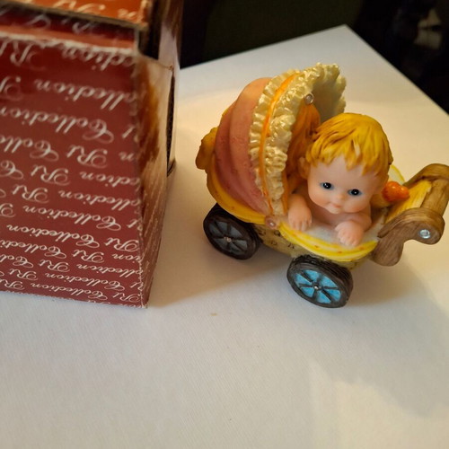 Decorative collectible baby stroller with baby and bottle like new