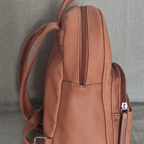Back pack tan used with internal and external pockets