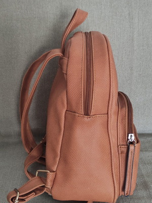 Back pack tan used with internal and external pockets