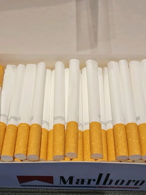 Cigarette filling device with empty cigarettes and filter