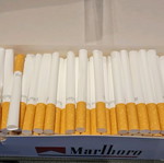 Cigarette filling device with empty cigarettes and filter