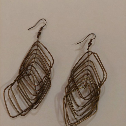 Dangling earrings used, brown and gold color