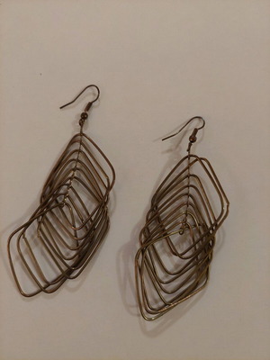 Dangling earrings used, brown and gold color