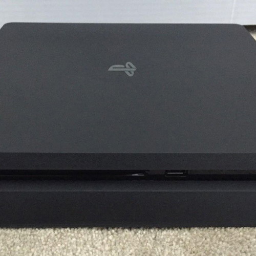 PlayStation 4 Slim console with charging dock, like new