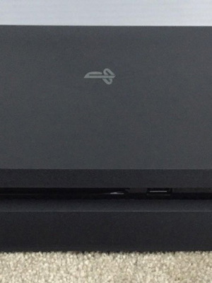 PlayStation 4 Slim console with charging dock, like new