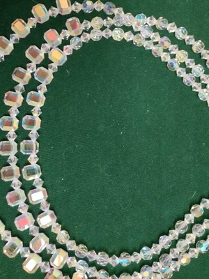 Necklace new with three rows of bright transparent stones, plastic and metal