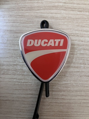 Ducati Official metal keychain with red and white enamel shield design