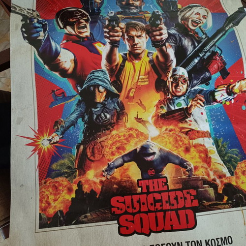 The Suicide Squad movie poster used with visible wear