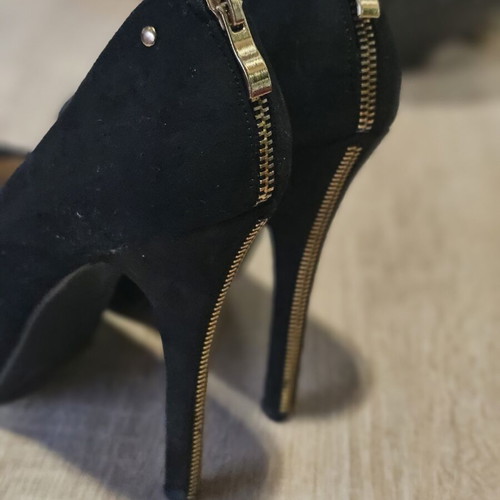 Black suede high heels with gold zipper