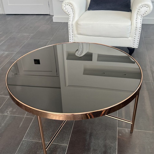 Round coffee table with glass top and metal frame