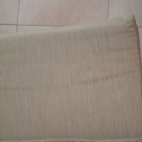 Light green fabric-covered stool with wooden legs