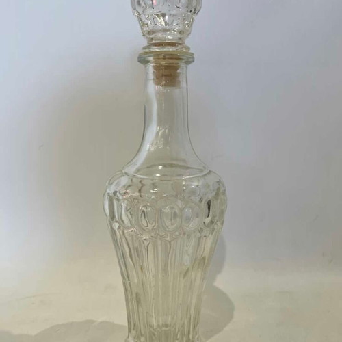 Vintage glass carafe with embossed designs used
