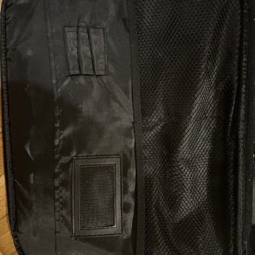 Black laptop bag with shoulder strap and pockets