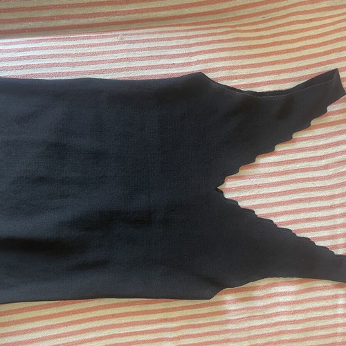 Black knitted sleeveless top with scalloped edges
