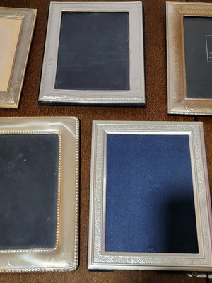Set of five used photo frames, one with broken glass
