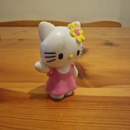 Hello Kitty figure used with pink dress and yellow flower